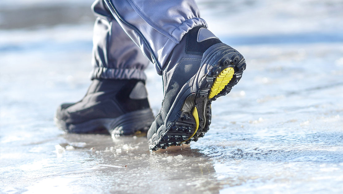 close up of winter boots walking on slushy ground