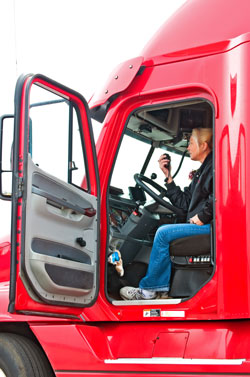 Man standing next to a blue semi