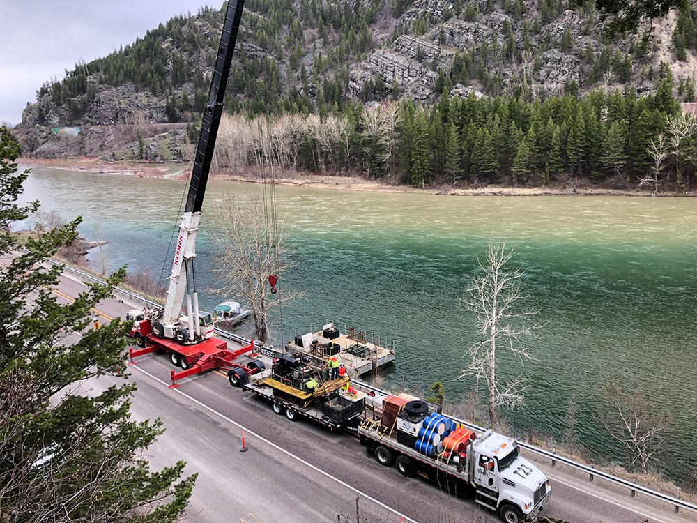 Construction vehicles on the road next to the Flathead River in Bad Rock Canyon Image