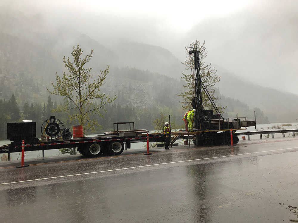 Road construction crews in Bad Rock Canyon working in the rain Image