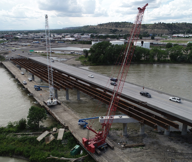 Crews placing the final steel bridge beams