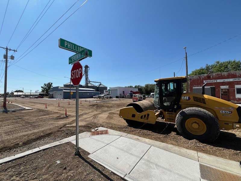 Looking south from the Phillips Street intersection, crews grade the road base in preparation for paving next week.