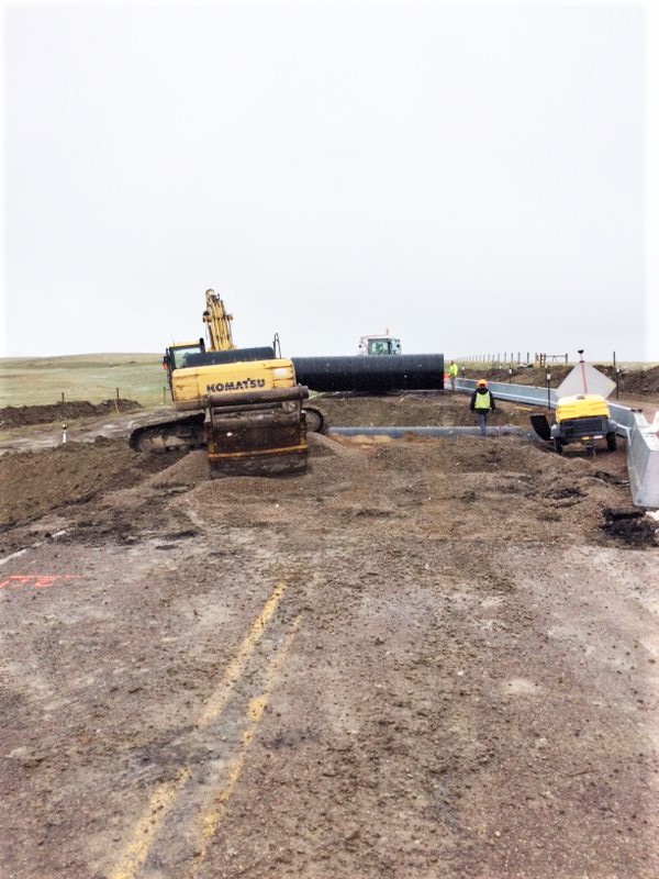 MP 14.5 Culvert being placed and single-lane detour on the right.