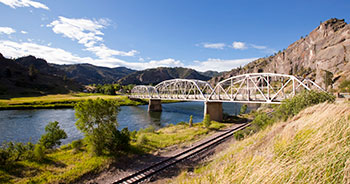 view of bridge over water and railroad tracks image