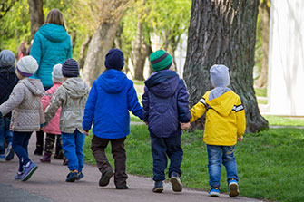 children walking with an adult image