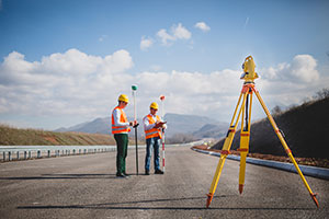 image of two workers surveying