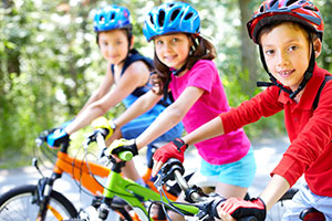 kids on bikes with helmets