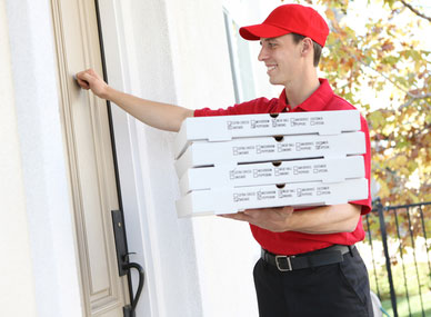 Man delivering pizza to a door