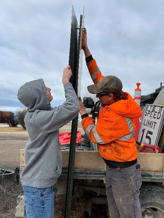 Students putting up the Power Volunteer FireDepartment sign