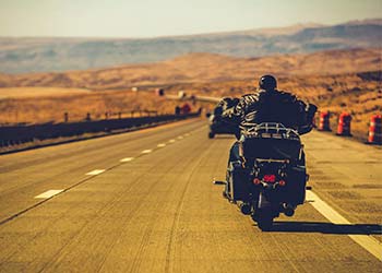 Person on motorcycle driving down the highway