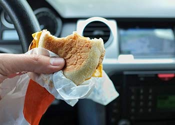 closeup of a hand holding a fast food burger